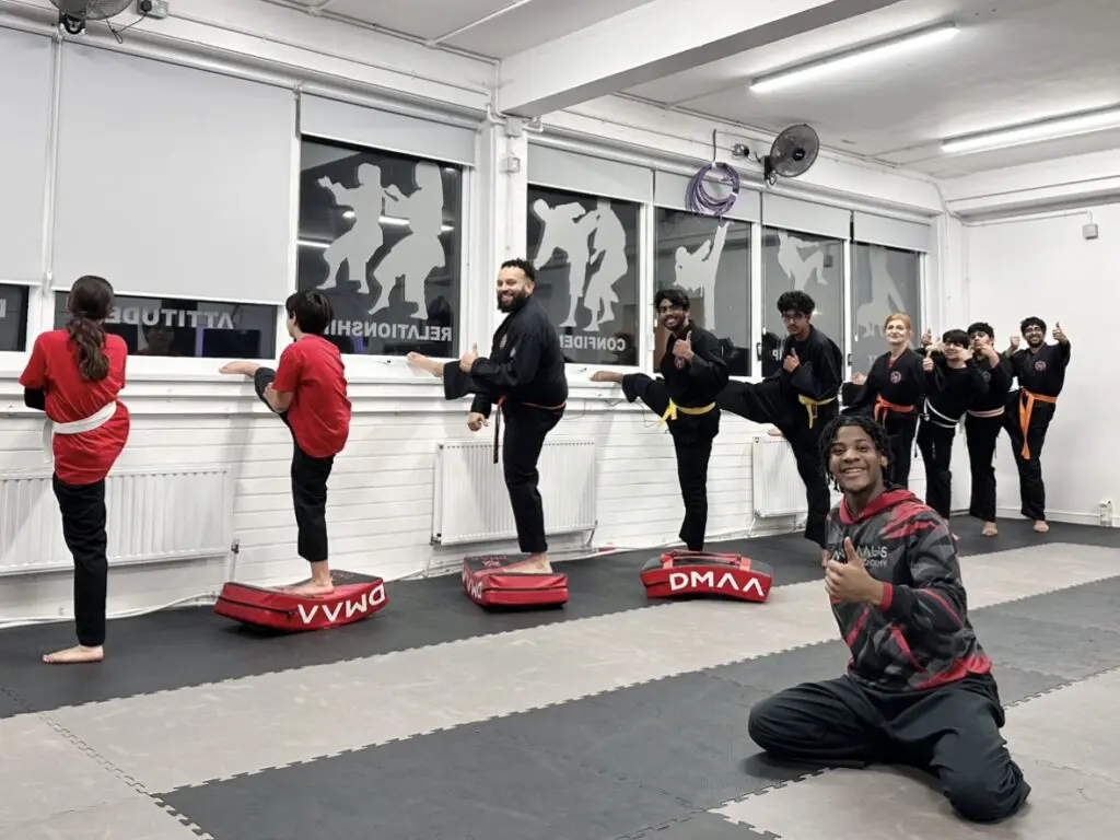 Adult martial arts students relaxing and socializing after training in Nottingham gym